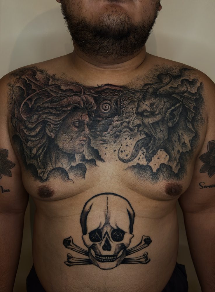 Blackwork chest piece with skull and crossbones